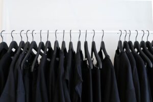 black t shirts hanging on rack